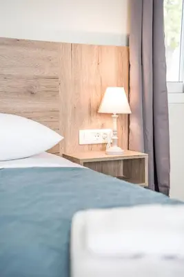 a bedroom with a bed and a table with a lamp at Dinas's Cottage Ideal Base for Balos and Elafonisi in Kaloudhianá