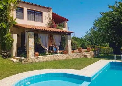 a house with a swimming pool in front of a house at Skine Dream Villa in Chania Town