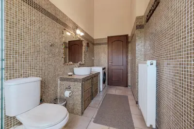 a bathroom with a toilet and a sink at Skine Dream Villa in Chania Town
