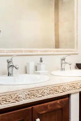 a bathroom with two sinks and a mirror at Villa Vallia - Villa Marina in Kato Galatas
