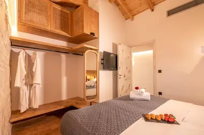 a bedroom with a bed with a bowl of fruit on it at Villa Armenus, private pool, garden, BBQ in Chania Town
