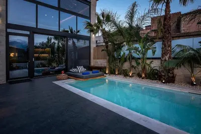 a swimming pool in front of a house at Villa Armenus, private pool, garden, BBQ in Chania Town