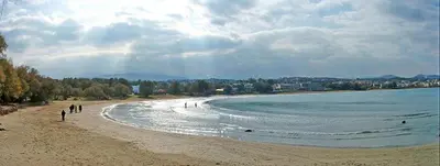 a group of people walking on the beach at Glaros Studios in Kalamaki Chanion