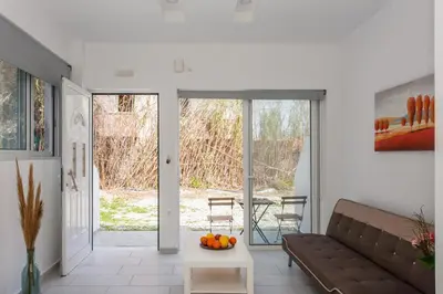 a living room with a couch and a table at Glaros Studios in Kalamaki Chanion