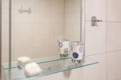 a glass shelf in a bathroom with a shower at Glaros Studios in Kalamaki Chanion