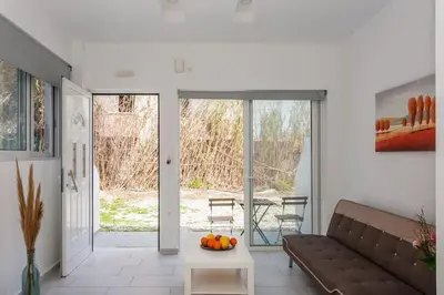 a living room with a couch and a table at Glaros Studios in Kalamaki Chanion