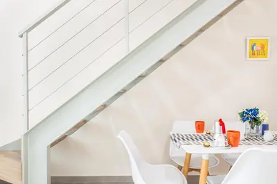 a white dining room with a white table and white chairs at Gallery Art Apartment Chania Crete in Chania Town