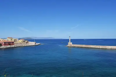 a lighthouse in the middle of a large body of water at Loft Art Gallery, Chania, Crete in Chania Town