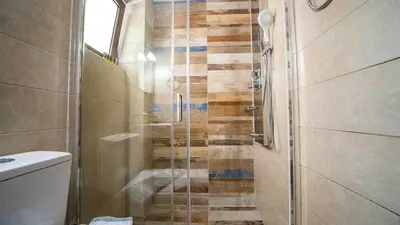 a bathroom with a shower with a glass door at Grand Olympia,Luxury, spacious indoor&outdoor area in Kissamos