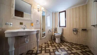 a bathroom with a sink and a toilet at Grand Olympia,Luxury, spacious indoor&outdoor area in Kissamos