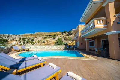 a villa with a swimming pool and a house at Grand Olympia,Luxury, spacious indoor&outdoor area in Kissamos