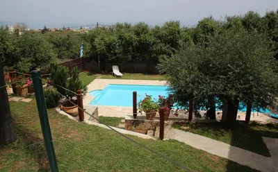 a swimming pool in a yard with trees at Villa Palma in Maleme