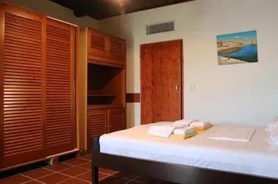 a bedroom with a bed with towels on it at Villa Palma in Maleme