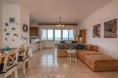 a living room with a couch and a table at Agiazi Beachfront Apartment in Chania Town