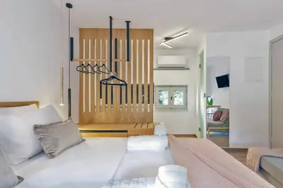 a living room with a large white bed in a room at Arch 4 Luxury Living in Chania Town