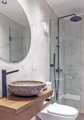 a bathroom with a stone sink and a shower at Arch 4 Luxury Living in Chania Town