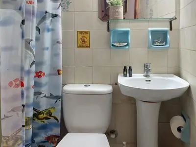 a bathroom with a toilet and a sink at Guesthouse Chryssoula in Chania Town