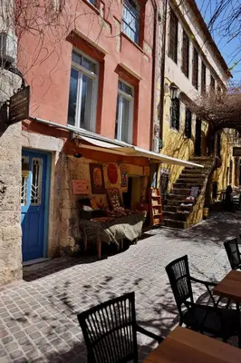 a group of chairs and tables in front of a building at Helianthi in Chania Town