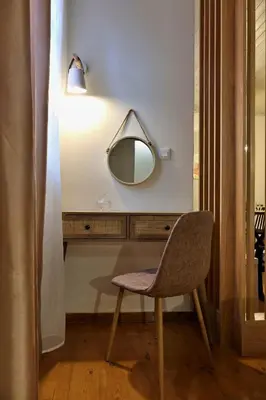 a chair and a mirror in a room at Helianthi in Chania Town