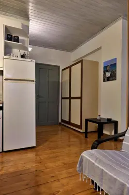 a room with a white refrigerator and a kitchen at Helianthi in Chania Town