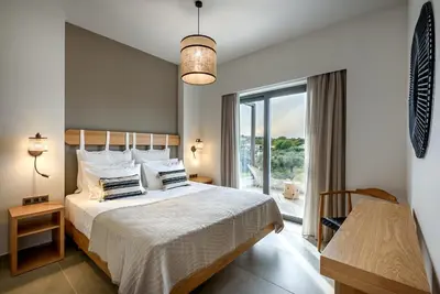 a bedroom with a bed and a large window at Soleado Villa Chania rooftop heated pool in Chania Town