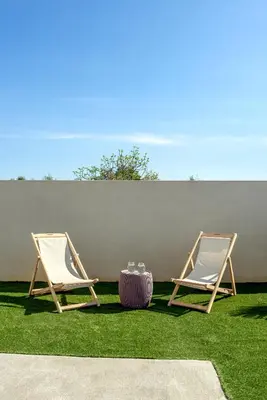 two chairs and a table on the grass at Soleado Villa Chania rooftop heated pool in Chania Town