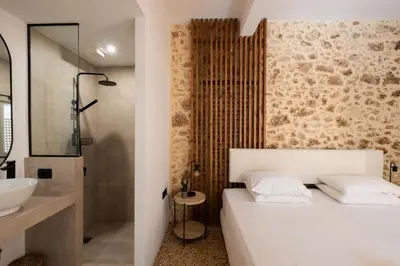 a bedroom with a white bed and a sink at MV Living - Studio in Chania Town