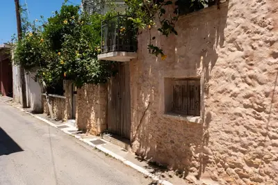 a stone building with a window and plants on it at MV Living - Studio in Chania Town