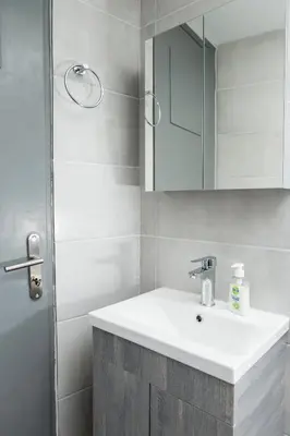 a bathroom with a white sink and a mirror at ERIS House in Kissamos