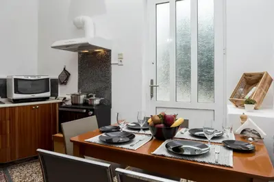 a kitchen with a table with a bowl of fruit on it at ERIS House in Kissamos