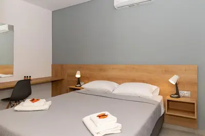 a bedroom with a bed with towels on it at Casa Del Mare Luxury Guest House in Chania Town