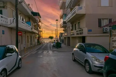 two cars parked on a street in front of buildings at Casa Del Mare Luxury Guest House in Chania Town
