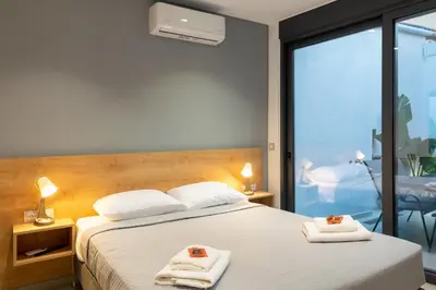 a bedroom with a bed with two towels on it at Casa Del Mare Luxury Guest House in Chania Town