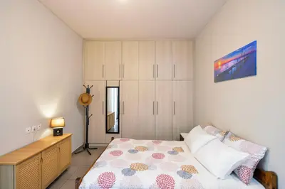a bedroom with a bed and a dresser at Souda apartment in Souda