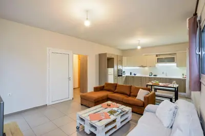 a living room with a couch and a table at Souda apartment in Souda