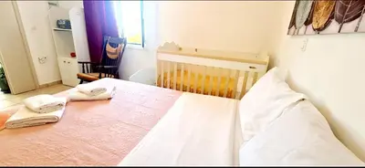 a bedroom with a bed with two towels on it at Kedrodasos House in Elafonisi