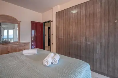 a bedroom with a bed with towels on it at Michael's Villa in Kissamos