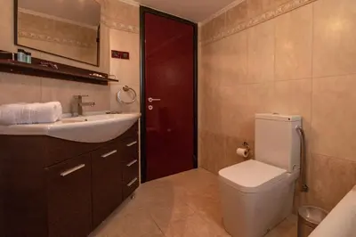 a bathroom with a toilet and a sink at Michael's Villa in Kissamos