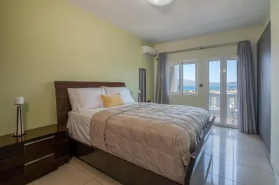 a bedroom with a bed and a large window at Michael's Villa in Kissamos