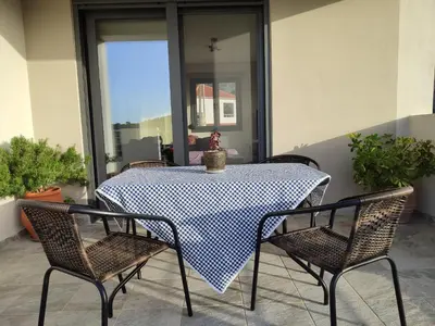 a black and white table and chairs on a patio at Villa Lakki's Ori in Lákkoi