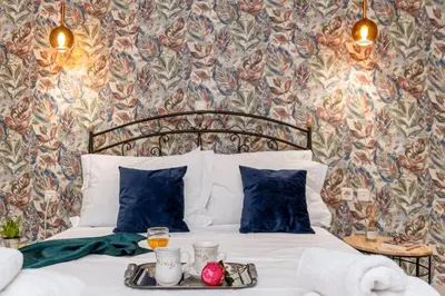 a bed with a tray with drinks on it at Laurel Heights Apartment in Chania Town