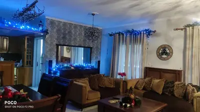 a living room with blue lights on the walls at Laurel Heights Apartment in Chania Town