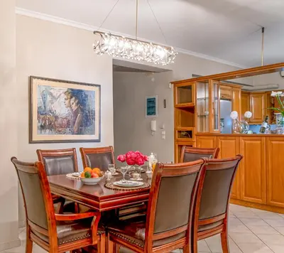 a dining room with a table and chairs at Laurel Heights Apartment in Chania Town