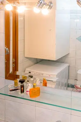 a bathroom with a counter with a sink and a mirror at Laurel Heights Apartment in Chania Town