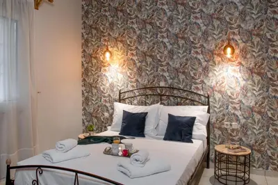 a bedroom with a bed with towels on it at Laurel Heights Apartment in Chania Town