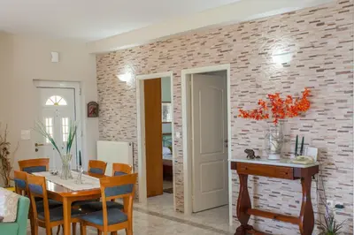 a dining room with a table and a brick wall at Aura Estate in Chania Town