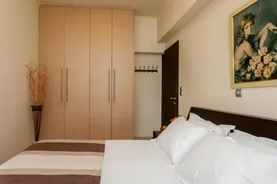 a bedroom with a bed and a large closet at Downtown apartment in Chania in Chania Town
