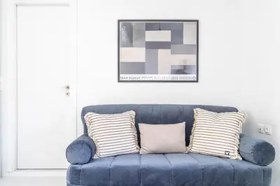 a blue couch with pillows in a living room at Armenous Green Dia's Mansion in Arménoi
