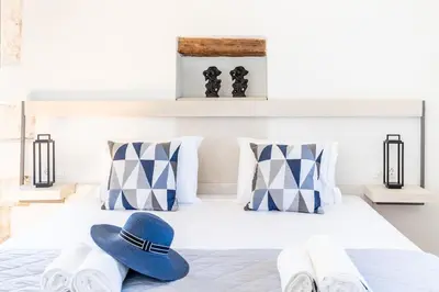 a pair of flip flops and a hat on a bed at Armenous Green Dia's Mansion in Arménoi