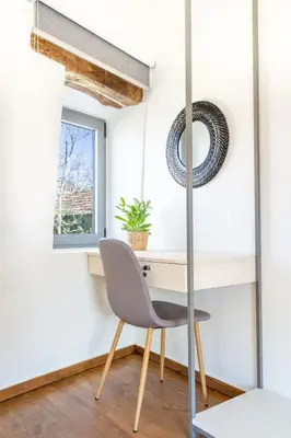 a desk and chair in a room with a window at Armenous Green Dia's Mansion in Arménoi